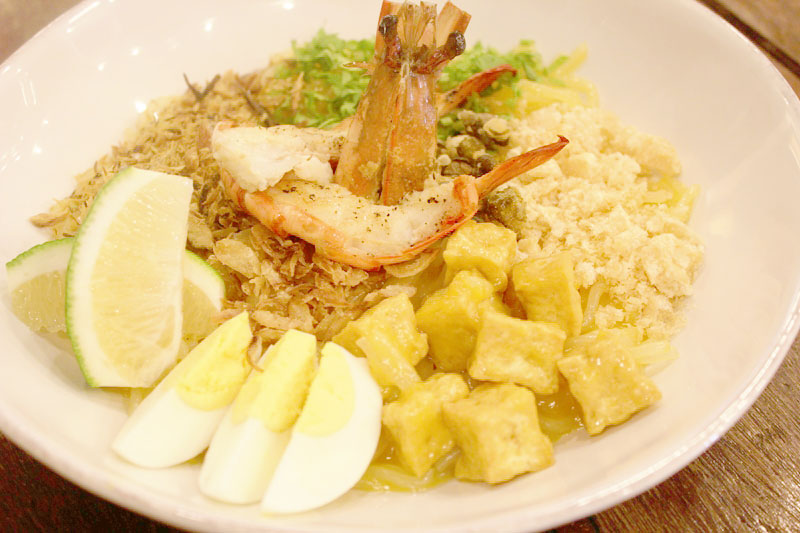 Pancit Palabok with shrimp, egg, and savory toppings at Happy Garden Cafe